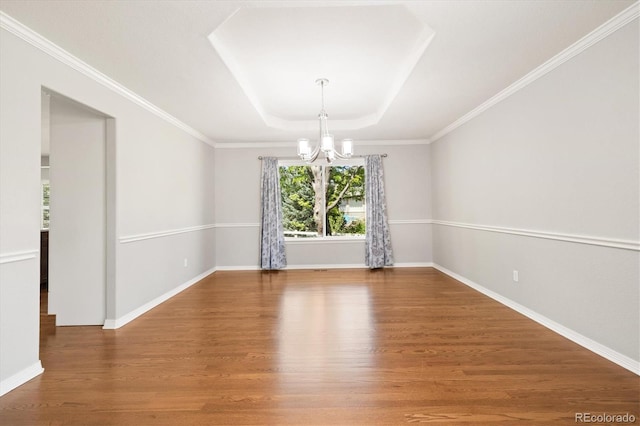 3901 Stonegrass Pt, Broomfield, CO 80023 - empty room featuring a chandelier, a tray ceiling, and wood finished floors