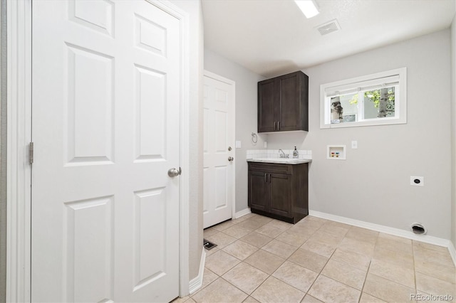 3901 Stonegrass Pt, Broomfield, CO 80023 - laundry room featuring electric dryer hookup, hookup for a washing machine, cabinet space, and light tile patterned flooring