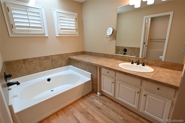 23846 Genesee Village Rd, Golden, CO 80401 - full bathroom featuring a bath, vanity, and wood finished floors