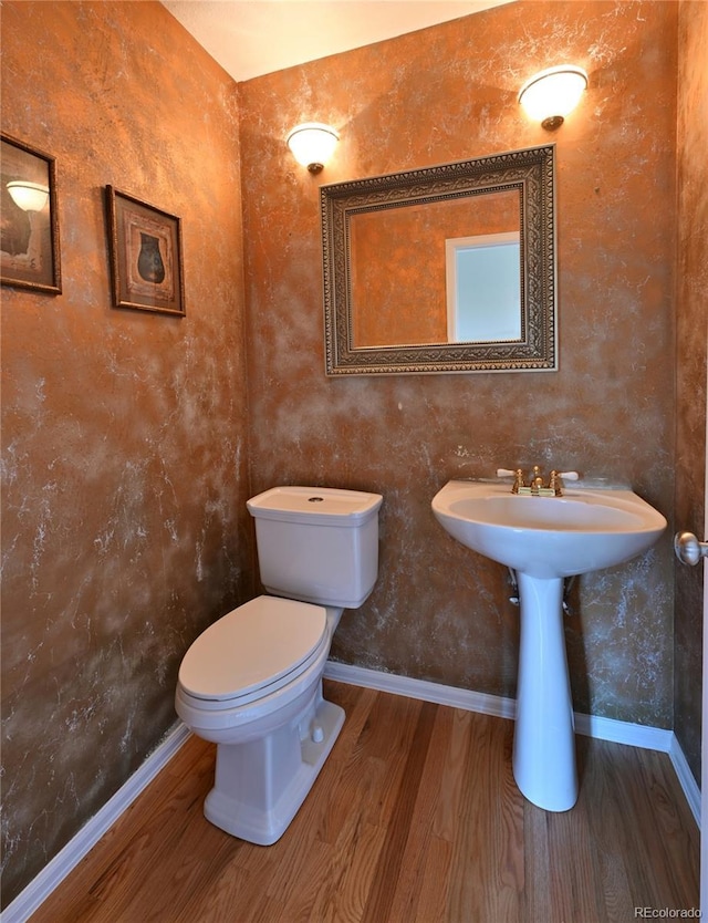 23846 Genesee Village Rd, Golden, CO 80401 - bathroom featuring wood finished floors, toilet, and baseboards