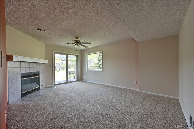 23846 Genesee Village Rd, Golden, CO 80401 - unfurnished living room featuring ceiling fan, carpet floors, a textured ceiling, baseboards, and a tiled fireplace