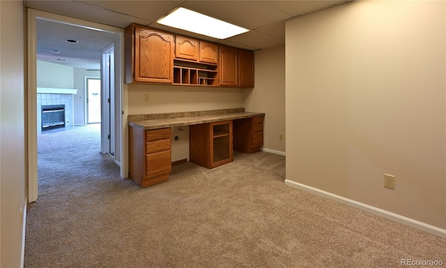 23846 Genesee Village Rd, Golden, CO 80401 - unfurnished office featuring light carpet, baseboards, and a tiled fireplace