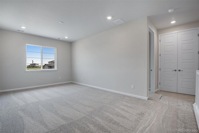 spare room with light colored carpet