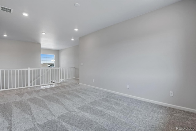 empty room featuring recessed lighting, light colored carpet, visible vents, and baseboards