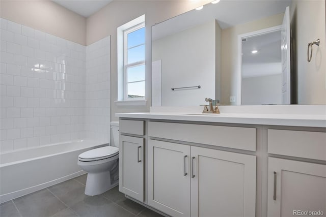 full bathroom with vanity, toilet, tiled shower / bath combo, and tile patterned floors