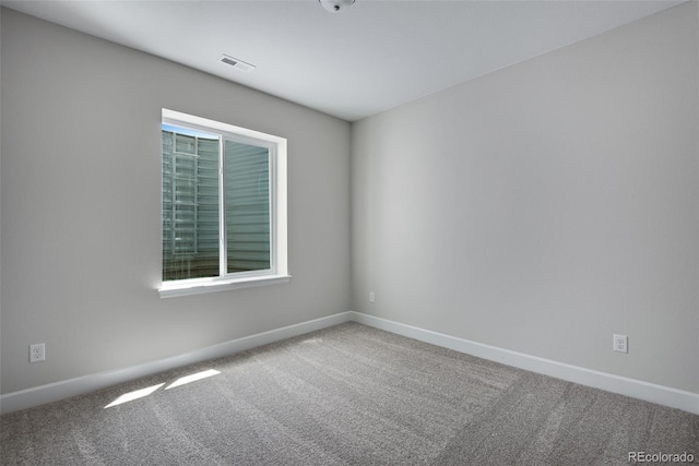 unfurnished room featuring visible vents, baseboards, and carpet floors