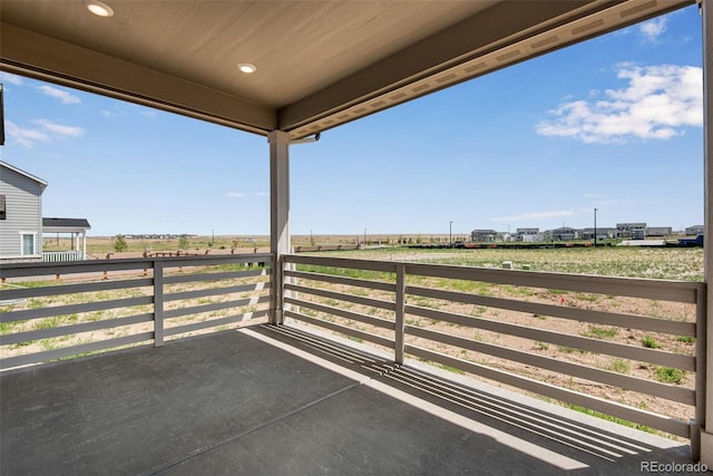 view of patio featuring a rural view and a balcony