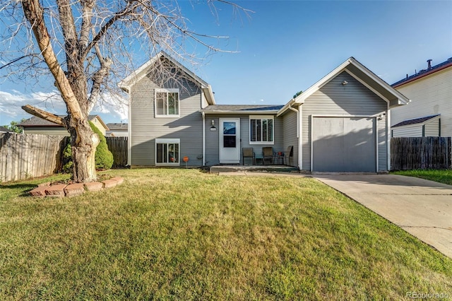 16980 E Stanford Ave, Aurora, CO 80015 - split level home featuring concrete driveway and a garage