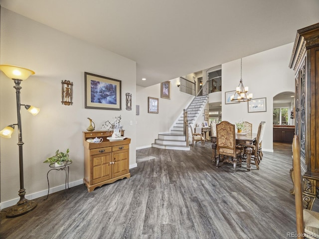 6432 S Robb Ct, Littleton, CO 80127 - dining area with dark wood finished floors, baseboards, stairway, arched walkways, and a chandelier