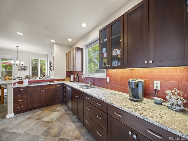 6432 S Robb Ct, Littleton, CO 80127 - kitchen featuring a sink, a peninsula, glass insert cabinets, decorative backsplash, and appliances with stainless steel finishes