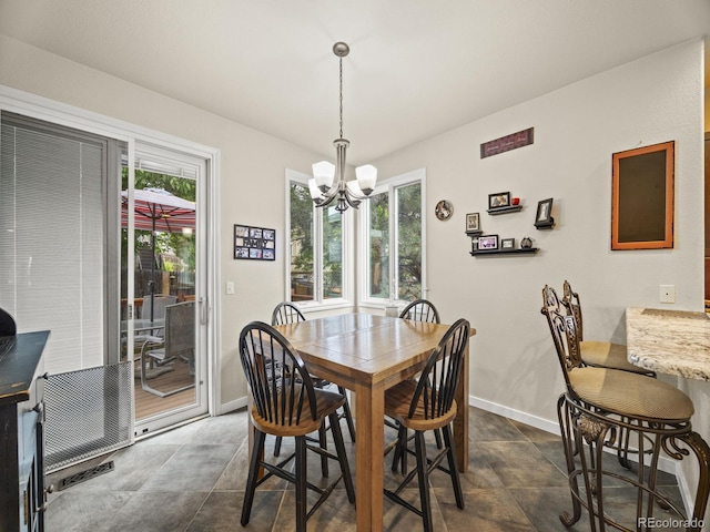 6432 S Robb Ct, Littleton, CO 80127 - dining space featuring a chandelier and baseboards