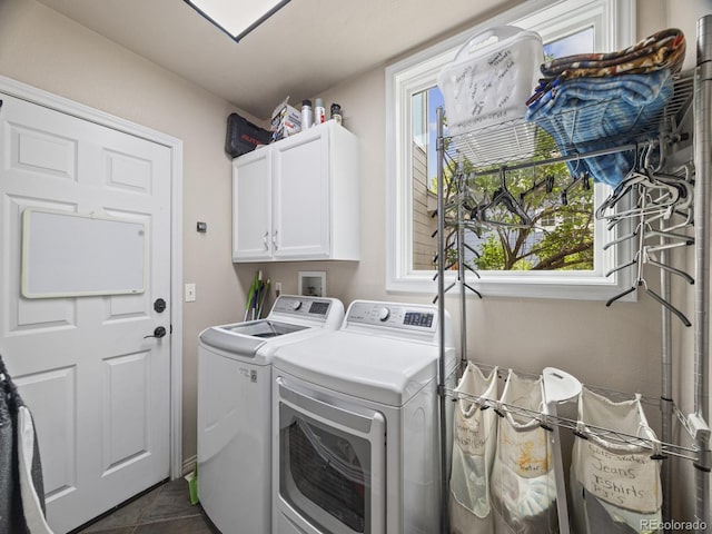 6432 S Robb Ct, Littleton, CO 80127 - washroom featuring cabinet space, washing machine and dryer, plenty of natural light, and dark tile patterned floors
