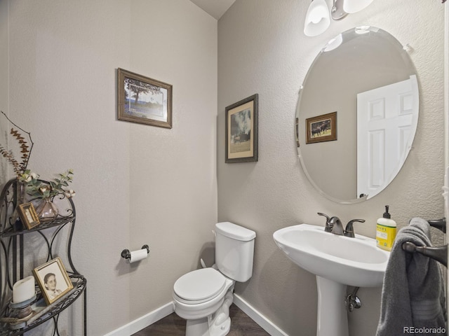 6432 S Robb Ct, Littleton, CO 80127 - half bathroom with wood finished floors, toilet, and baseboards