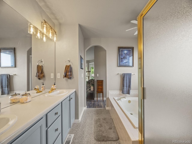 6432 S Robb Ct, Littleton, CO 80127 - bathroom with double vanity, a bath, baseboards, and a ceiling fan
