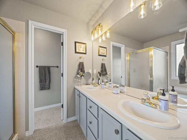 6432 S Robb Ct, Littleton, CO 80127 - bathroom with double vanity, a shower stall, and baseboards