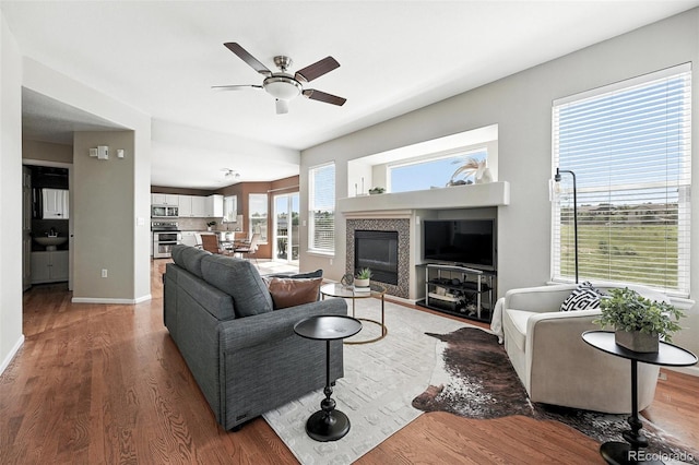 3543 Foxridge Trl, Highlands Ranch, CO 80126 - living room featuring ceiling fan, wood finished floors, and a glass covered fireplace