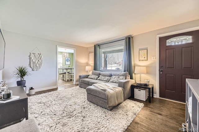living room with baseboards and wood finished floors