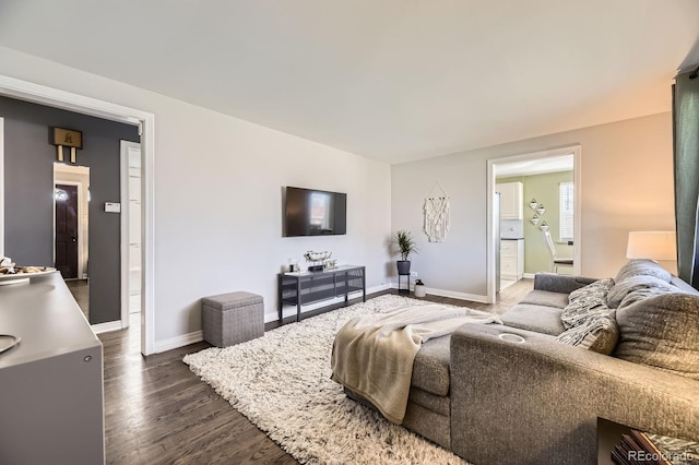 living area with dark wood finished floors and baseboards