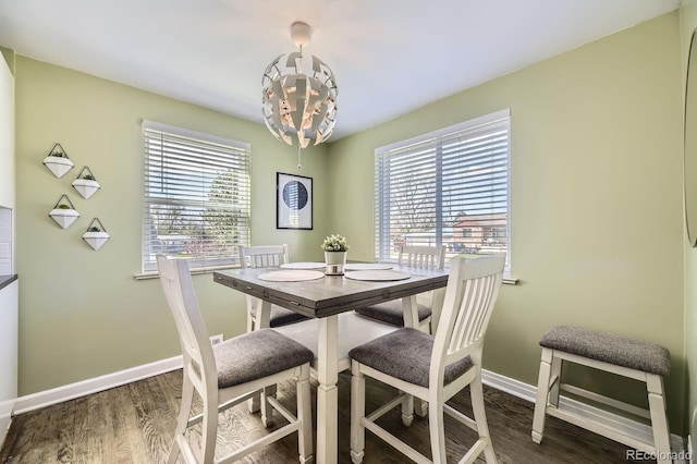 dining room with plenty of natural light, wood finished floors, and baseboards