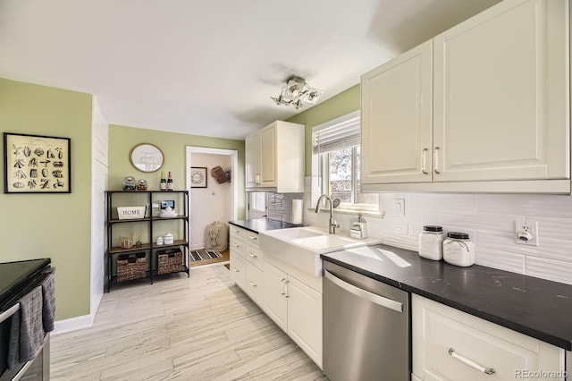 kitchen featuring light wood finished floors, white cabinets, a sink, decorative backsplash, and dishwasher