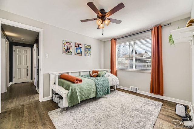 bedroom featuring baseboards, visible vents, and dark wood-style floors