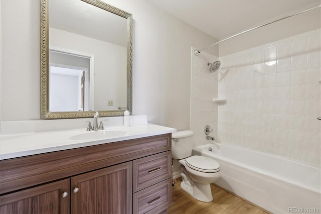 bathroom with toilet, vanity, tub / shower combination, and wood finished floors