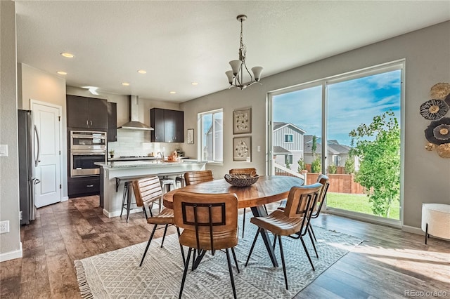 638 W 175th Ave, Broomfield, CO 80023 - dining area featuring a chandelier, wood finished floors, and recessed lighting