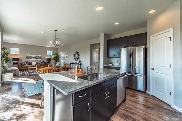 638 W 175th Ave, Broomfield, CO 80023 - kitchen featuring appliances with stainless steel finishes, a chandelier, dark wood finished floors, recessed lighting, and dark stone counters