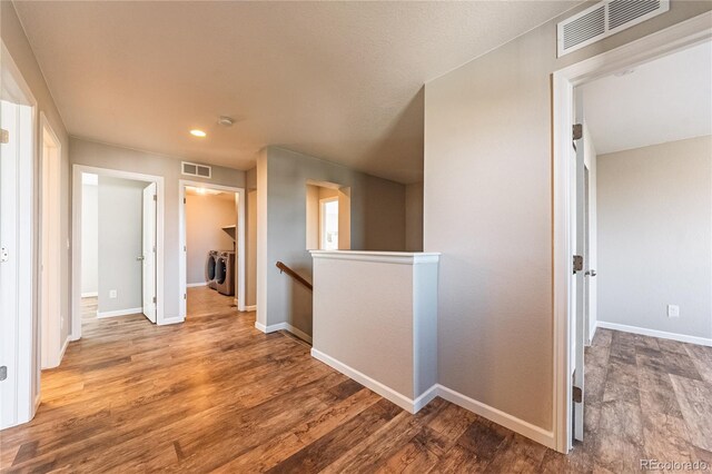 638 W 175th Ave, Broomfield, CO 80023 - hallway with an upstairs landing, washer and dryer, wood finished floors, and recessed lighting