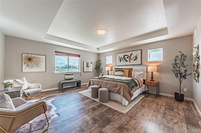 638 W 175th Ave, Broomfield, CO 80023 - bedroom featuring a tray ceiling and wood finished floors