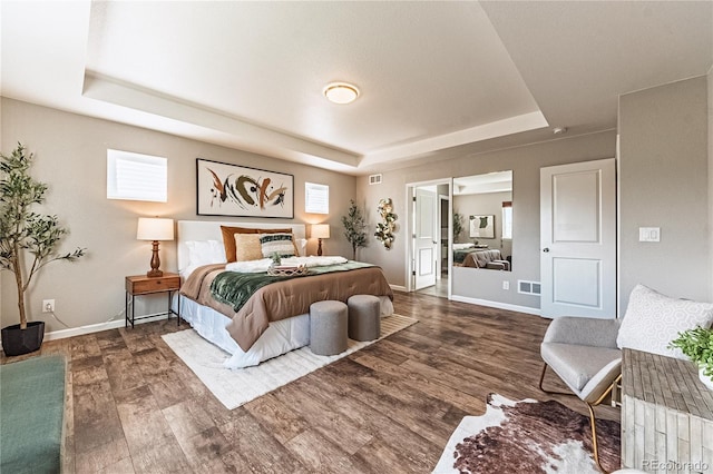 638 W 175th Ave, Broomfield, CO 80023 - bedroom featuring a tray ceiling, wood finished floors, and multiple windows