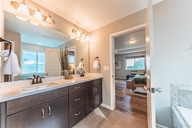 638 W 175th Ave, Broomfield, CO 80023 - ensuite bathroom featuring double vanity, a tub to relax in, and tile patterned flooring