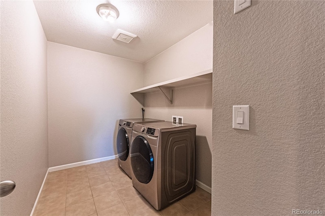 638 W 175th Ave, Broomfield, CO 80023 - washroom with washing machine and dryer, light tile patterned floors, and a textured wall