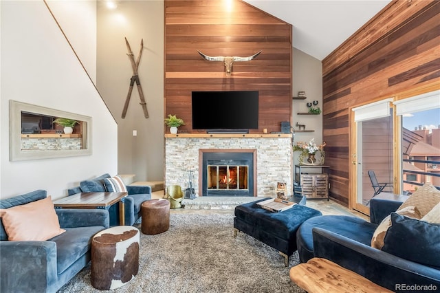 91200 Ryan Gulch Rd Unit 91222, Silverthorne, CO 80498 - living area featuring wooden walls, high vaulted ceiling, a fireplace, and carpet flooring