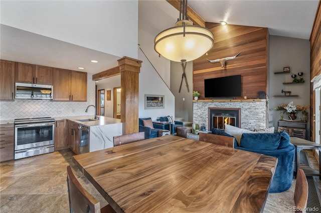 91200 Ryan Gulch Rd Unit 91222, Silverthorne, CO 80498 - dining space with high vaulted ceiling and a fireplace