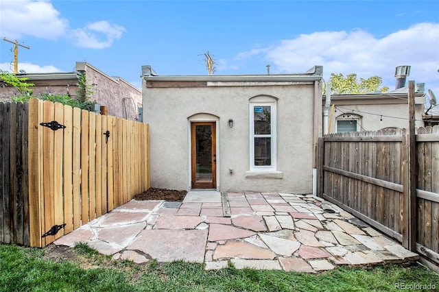 2530 Kensing Ct, Denver, CO 80211 - back of property with stucco siding, a gate, and a patio area