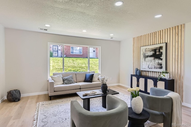 9263 E Nassau Ave, Denver, CO 80237 - living area featuring baseboards, a textured ceiling, recessed lighting, and wood finished floors