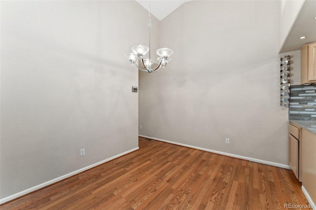 4195 W 111th Cir, Westminster, CO 80031 - unfurnished dining area featuring a chandelier, light wood-style floors, baseboards, and high vaulted ceiling