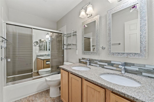 4195 W 111th Cir, Westminster, CO 80031 - full bathroom featuring toilet, double vanity, and combined bath / shower with glass door