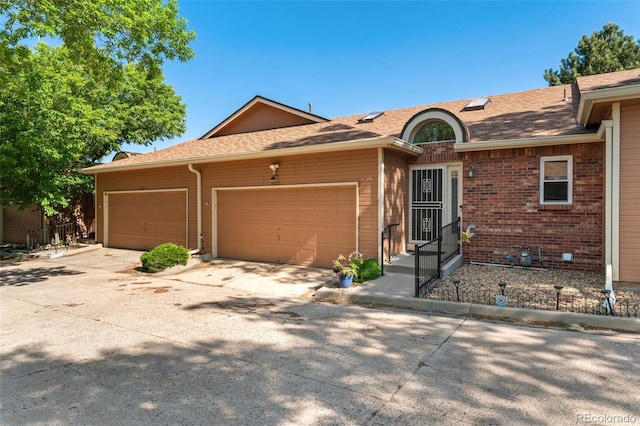 4195 W 111th Cir, Westminster, CO 80031 - ranch-style home with an attached garage, concrete driveway, roof with shingles, and brick siding