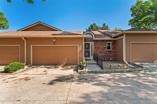 4195 W 111th Cir, Westminster, CO 80031 - ranch-style house with a garage, driveway, roof with shingles, and brick siding