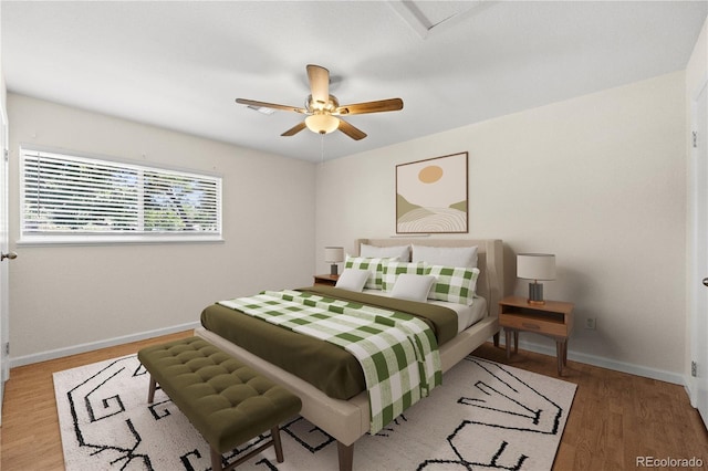 bedroom with wood-type flooring and ceiling fan