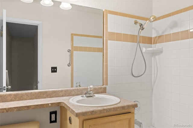 bathroom with vanity and a tile shower