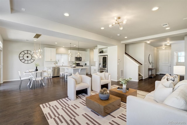 6689 Backcountry Loop, Colorado Springs, CO 80927 - living room featuring a chandelier, dark wood-style floors, stairway, and recessed lighting