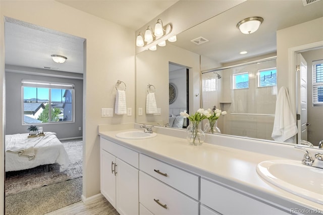 6689 Backcountry Loop, Colorado Springs, CO 80927 - ensuite bathroom with double vanity, plenty of natural light, and a stall shower