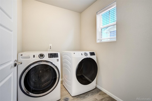 6689 Backcountry Loop, Colorado Springs, CO 80927 - washroom with separate washer and dryer and light wood-type flooring