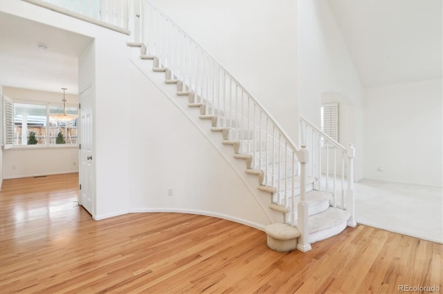 stairs with hardwood / wood-style flooring