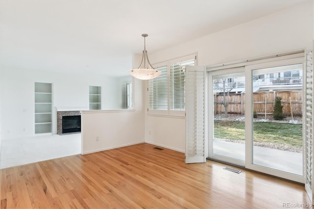 unfurnished dining area with light wood-type flooring