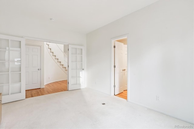 unfurnished room with french doors and carpet floors