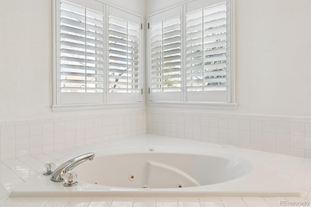 bathroom featuring tiled tub